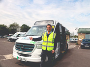 Councillor Richard Wilkins points to the new electric minibus in Frome, parked at a Somerset Council depot