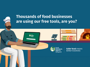 Chef using a laptop in a food business setting with FSA logo, promoting free tools for food safety and guidance for businesses.
