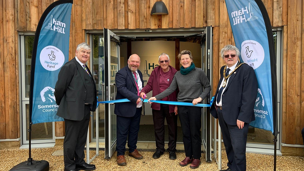 Ribbon cutting outside the new Ham Hill Visitor Centre, with people gathered between Somerset Council and Ham Hill banners at the entrance.