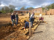 Volunteers building a traditional dry stone wall outside Ham Hill Visitor Centre using locally sourced Hamstone.