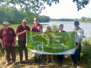 Chard Ranger Hannah Stanton (second from right) with volunteers at Chard Reservoir celebrating the site’s 2026 Green Flag Award.