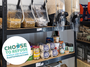 Refill shop shelves stocked with loose pasta, rice and household essentials, promoting plastic-free shopping and reusable containers.
