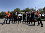 SUEZ recycling staff, fire service personnel and council representatives stand beside a fire engine promoting safe battery disposal.