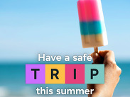 Roadside ice lolly beside a beach with the message "Have a safe T.R.I.P. this summer" promoting summer journey safety.