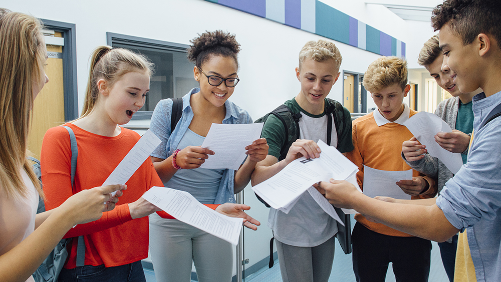 Students celebrate their exam results with cheers and smiles after receiving their grades at school results day.