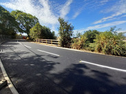 New road surface on Station Road, Castle Cary, following complex sinkhole and culvert repairs that have restored access.
