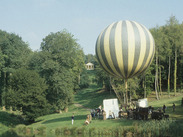 A hot air balloon next to a body of water during the filming of Pandaemonium in Hestercombe, Somerset.