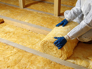 Loft insulation fitted between roof joists to improve a home’s energy efficiency.