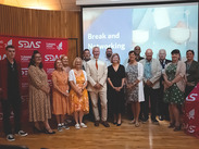Graduates and supporters gather on stage at the SDAS Peer Mentor Programme celebration event in Taunton.