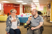 people sitting with a coffee in hand