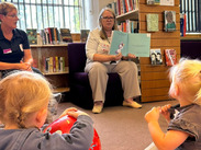 Children being read to in a library.