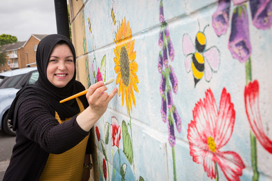 Local resident Warda with one of the murals