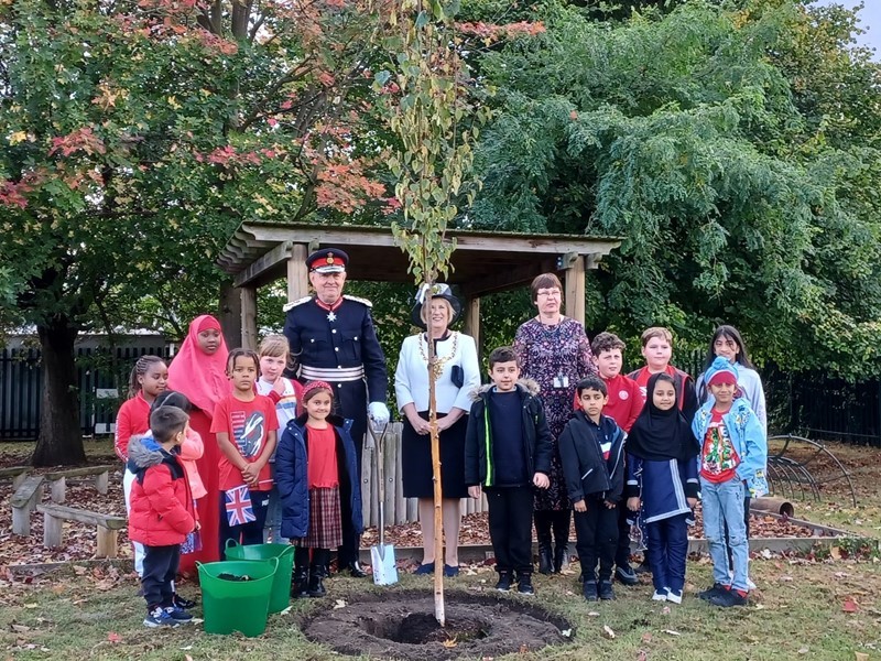 Pupils, headteacher, Lord-Lieutenant of South Yorkshire and Lord Mayor plant Queen's Green Canopy tree at Acres Hill Community Primary School