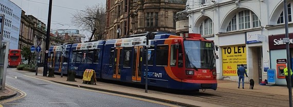 Supertram going down High Street in Sheffield