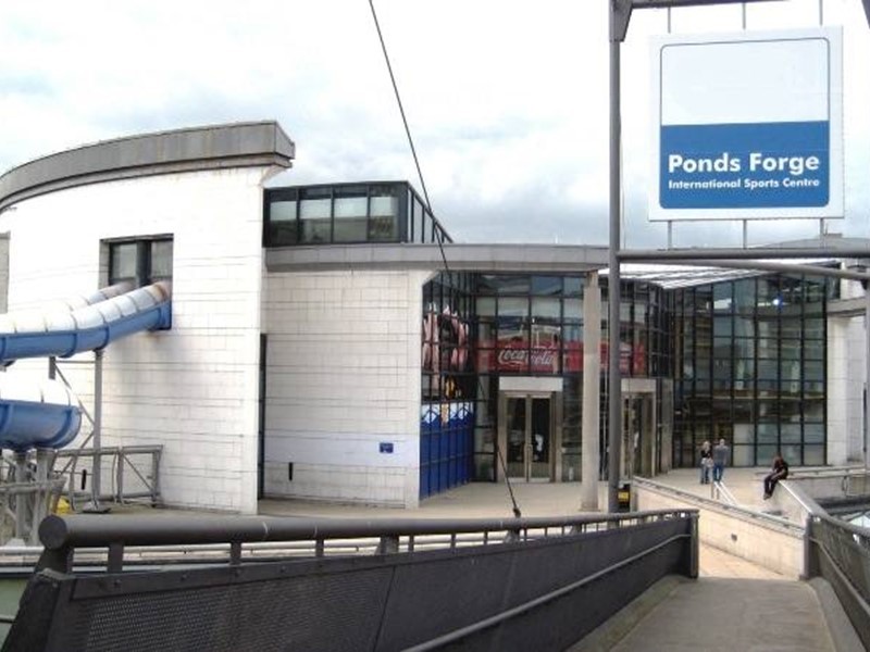 Exterior show of Ponds Forge with white walls and glass frontage and sign