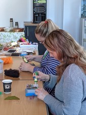 A photo of parents doing a creative craft