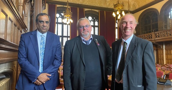 Shaffaq Mohammed, Terry Fox, Douglas Johnson smile in the town hall chamber