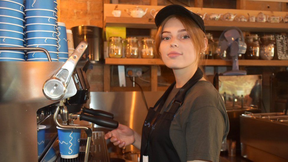 Yuliia Sharmankina at a coffee making machine