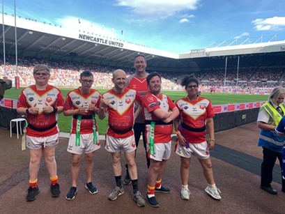 Picture  of 6 men in rugby kit at Newcastle Unite stadium.