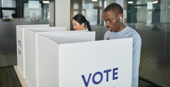 two people voting in booths