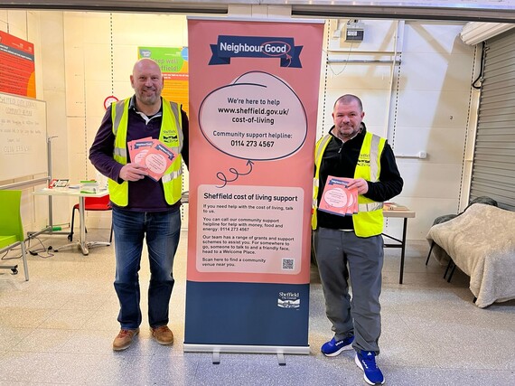 Two men in the Moor Market at a welcome space