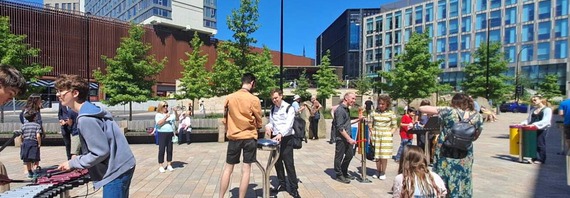 People play on large musical instruments in Sheffield city centre