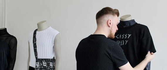 Mason Kane Thomas installing his Pride Month exhibition