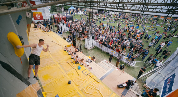 Image from the previous Cliffhanger event at Devonshire Green, with a climber on the wall while audience watches him