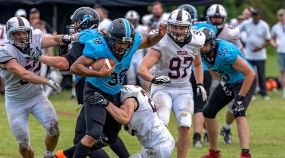 Sheffield Giants in a match against Birmingham Bulls, with players tackling each other