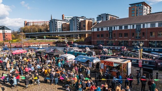 Groups of people socialising and having a great time in the sunshine at previous Quayside Market on Victoria Quays