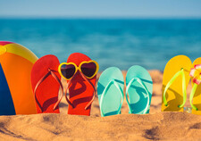 A line of flipflops in the sand