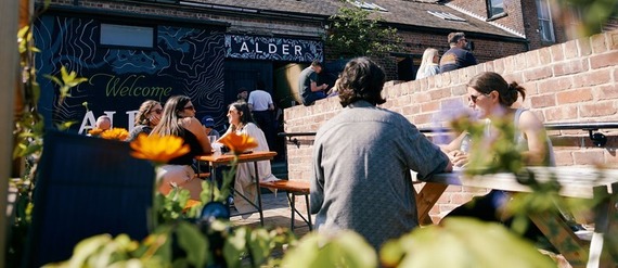 People socialising at the tables outside the Alder Bar in Neepsend as the sun is shining