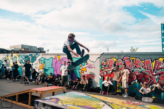 A skateboarder is jumping over a ramp with impressive skill.  Photo credit: Rhys Belding