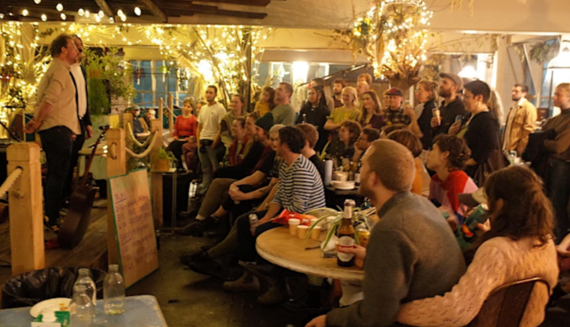 People laughing and smiling whilst  enjoying the celebration of the Pickle Champion. 