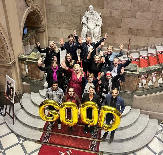 Councillors and officers celebrating Ofsted rating with balloons that read "Good"