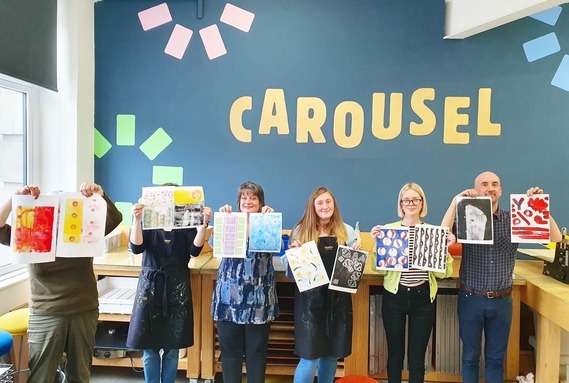 Carousel courses members proudly showing their art 