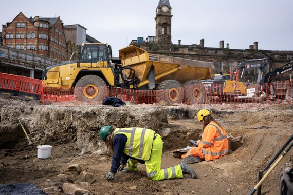 Archaeologists investigate and record the moat