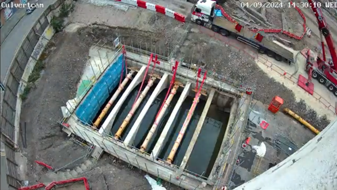 A still from the culvert cam timelapse. Taken from above, it shows the daylighted river.