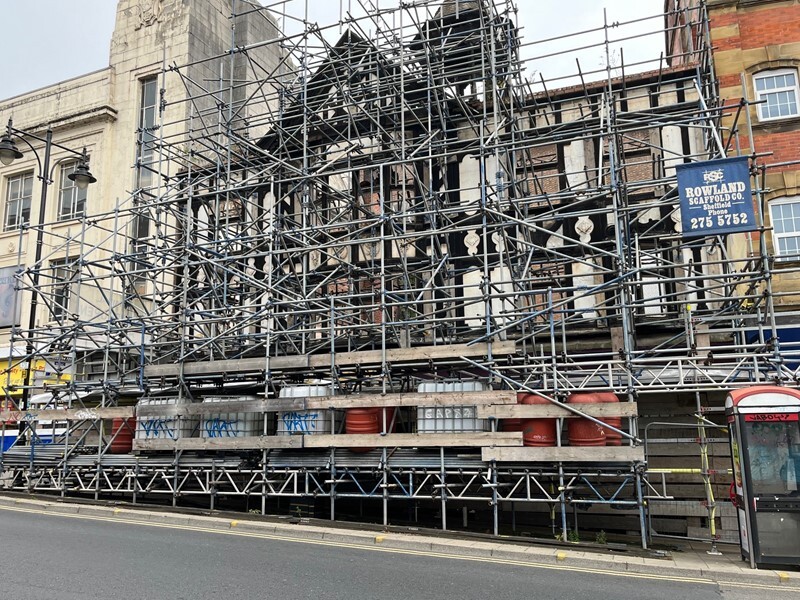 The facade of Haymarket in Sheffield, covered in scaffolding on a cloudy day
