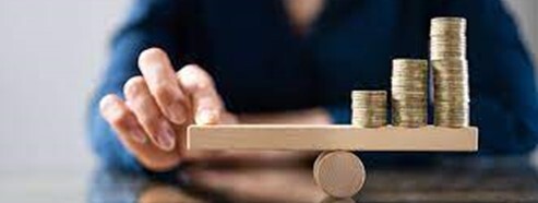Pound coins on a mini seesaw