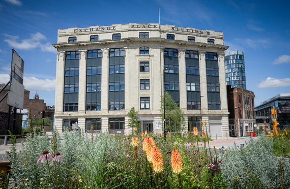 The beautiful old Yorkshire Artspace building at Exchange Place on a sunny day, with Grey to Green planting in the foreground