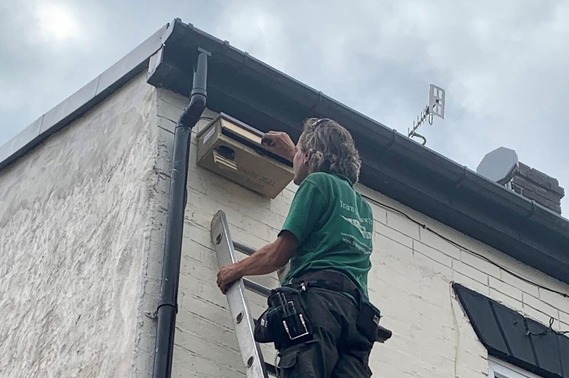 A swift nest box being installed on a home