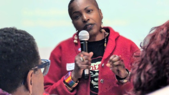 woman speaking into microphone at an event