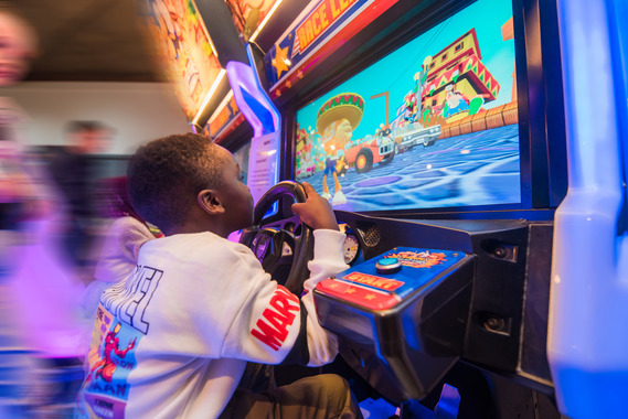 A child playing a cartoon racing game at the National Videogame Museum