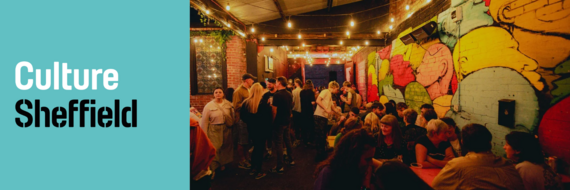 people drinking in a pub under red and amber ambient lighting