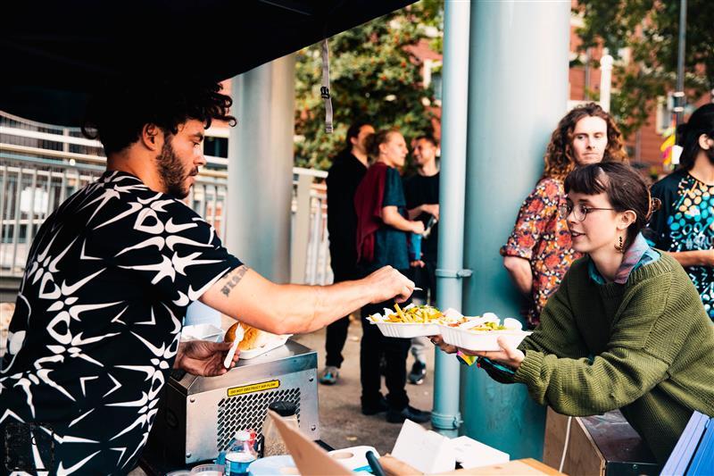 A street food stall serving chips to festival attendees
