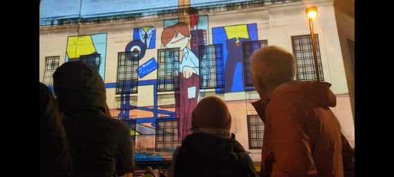 Pete McKee projection on the side of Central Library