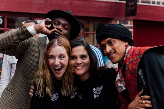 Group of people smiling and laughing in front of camera.