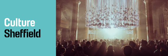 Culture Sheffield logo alongside a chandelier-like sculpture of some swallows above an attentive crowd.