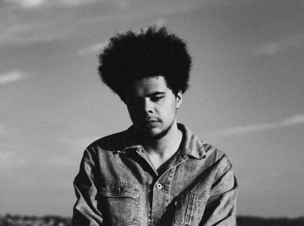 A black and white headshot of Otis Mensah